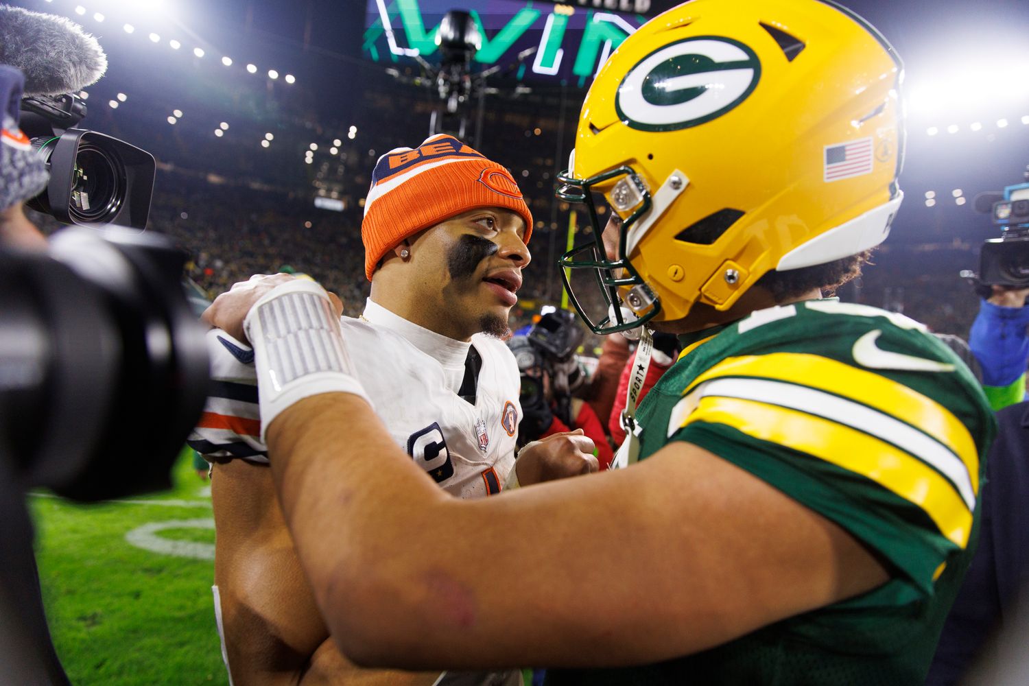 Justin Fields talks with Jordan Love after the Packers won the finale.